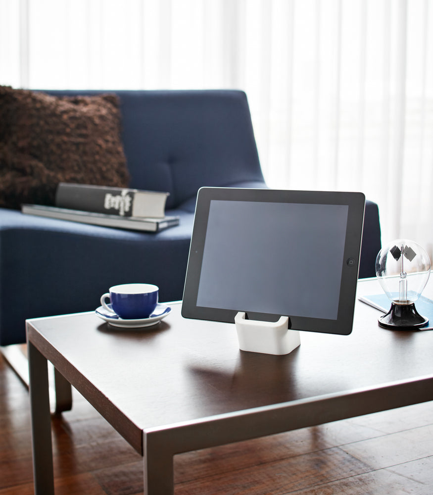 View 2 - White Tablet Stand holding tablet on coffee table by Yamazaki Home.