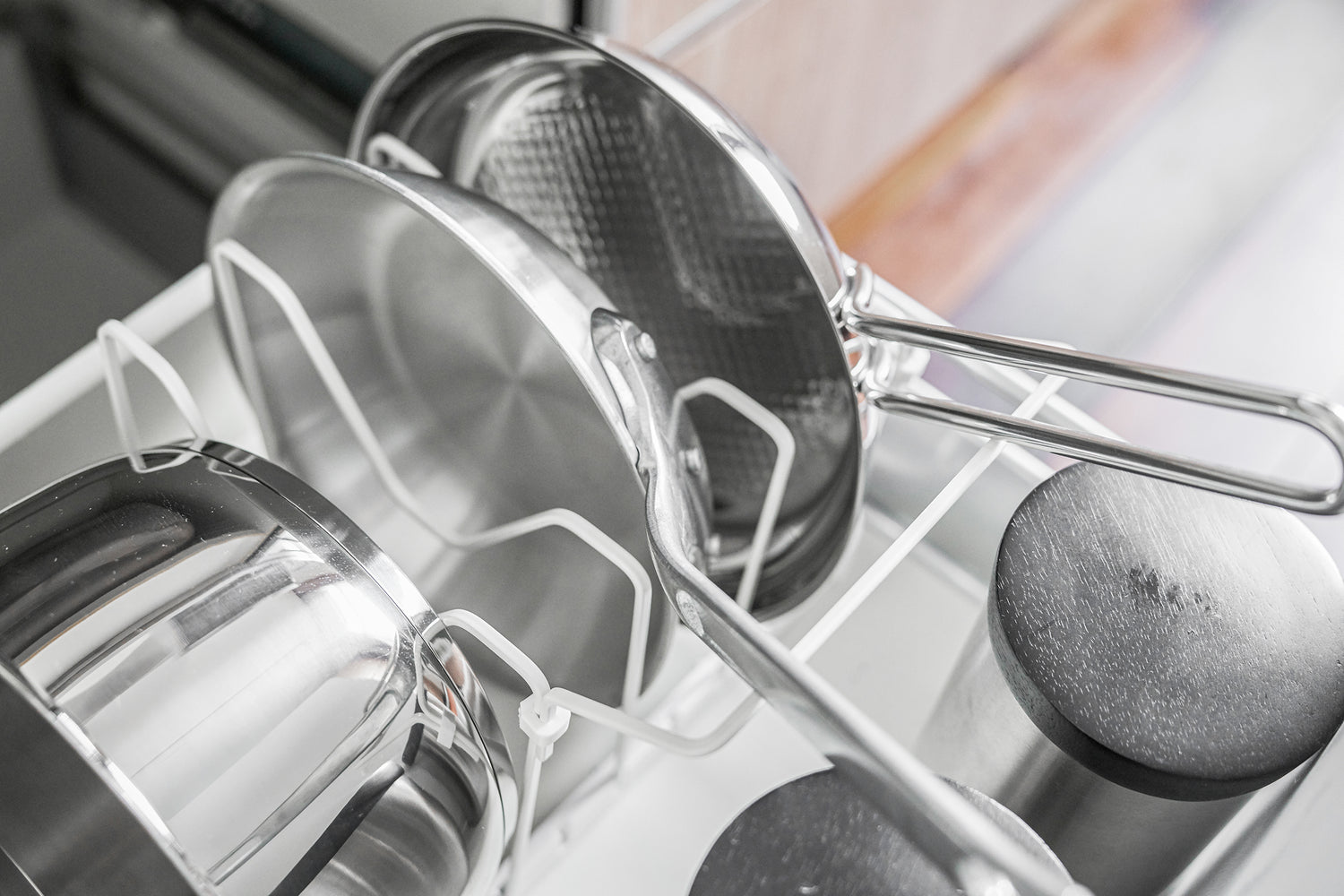 View 5 - Black Slim Dish Rack holding silverware and dishware on kitchen counter by Yamazaki Home.