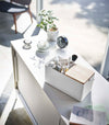 Closed white Makeup Organizer holding makeup on countertop by Yamazaki Home.