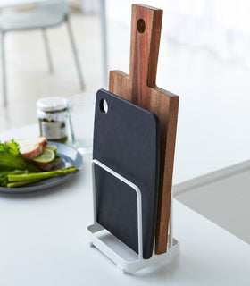 White Cutting Board Stand displaying cutting boards on countertop by Yamazaki Home. view 2