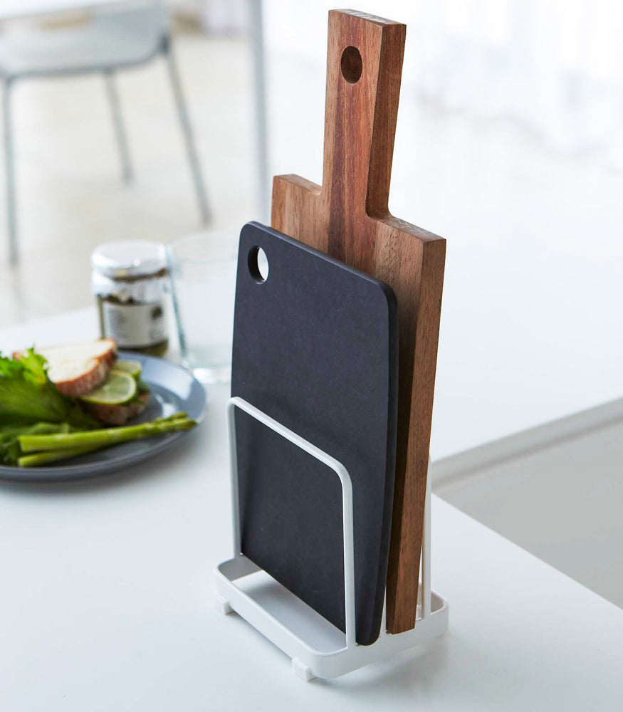 View 2 - White Cutting Board Stand displaying cutting boards on countertop by Yamazaki Home.