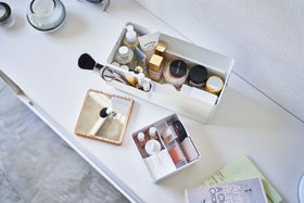 Aerial view of open white Makeup Organizer and comparments holding makeup products on table by Yamazaki Home. view 5
