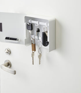 Close up view of white Square Magnetic Key Cabinet holding keys by Yamazaki Home. view 2