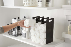 Black Towel Storage Organizer displaying towels in laundry room by Yamazaki Home. view 10