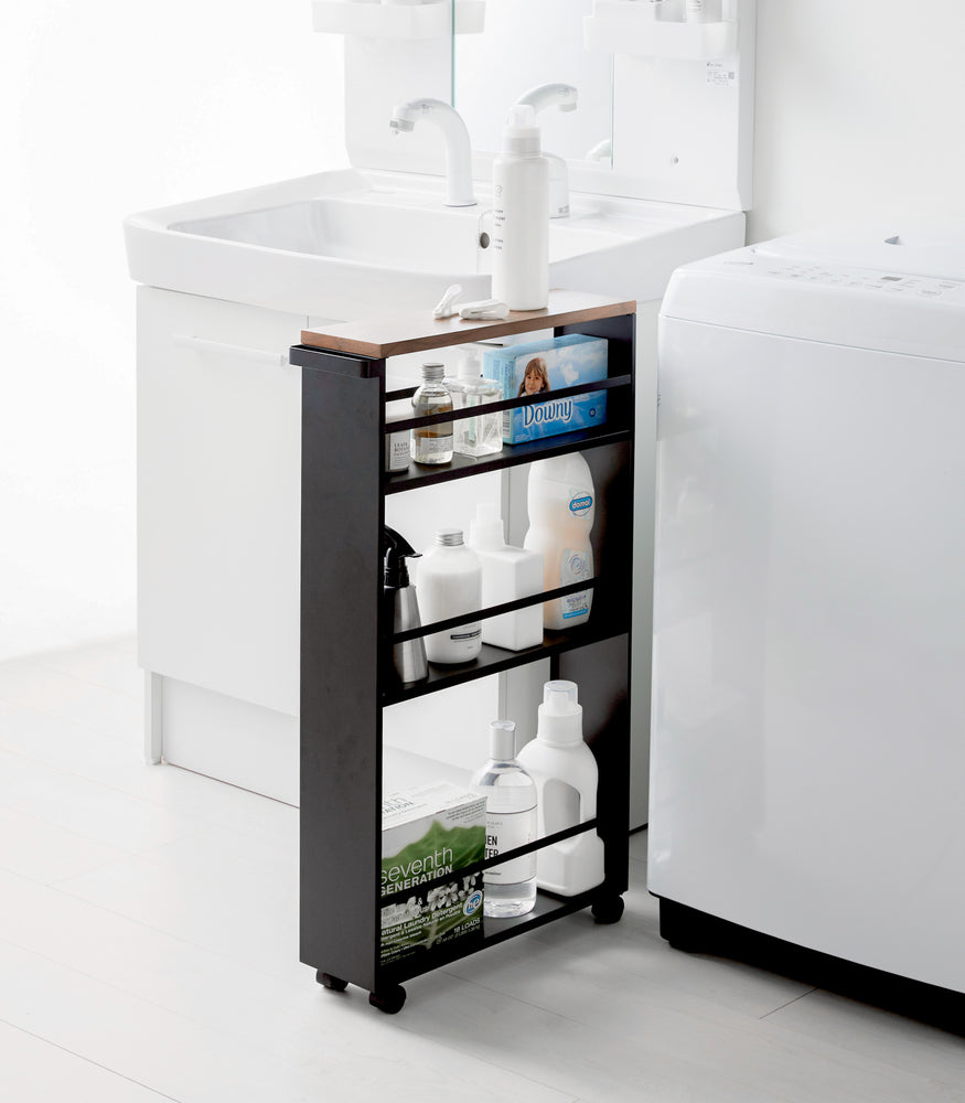 View 12 - Black Rolling Storage Cart holding cleaning supplies in bathroom by Yamazaki Home.