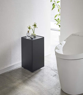 Black Rolling Bathroom Organizer with décor on top in bathroom by Yamazaki Home. view 8
