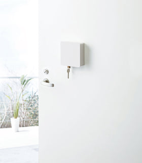 White Square Magnetic Key Cabinet holding key on door by Yamazaki Home. view 2