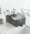 Side view of black Dish Rack holding dishware on kitchen counter by Yamazaki Home.