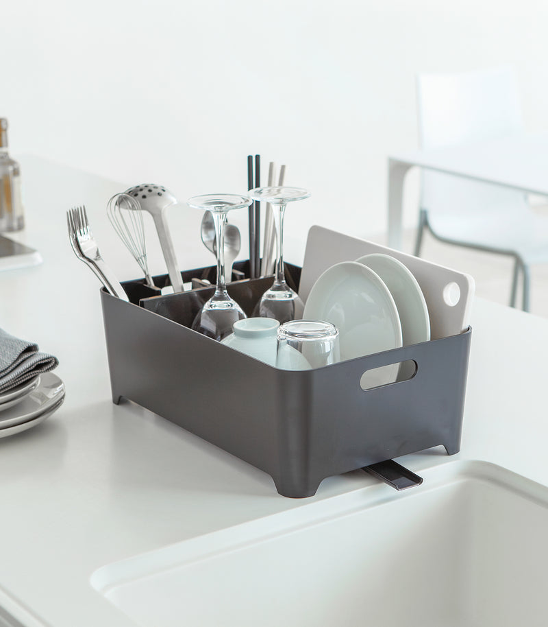 Side view of black Dish Rack holding dishware on kitchen counter by Yamazaki Home.