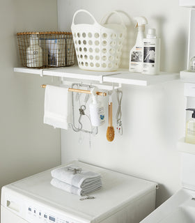 White Undershelf Hanger in laundry room holding cleaning items by Yamazaki Home. view 4