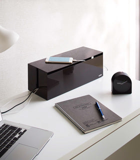 Brown Cable Management Box holding charging cords on desk by Yamazaki Home. view 8