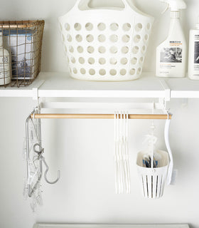 Front view of white Undershelf Hanger in laundry room by Yamazaki Home. view 3