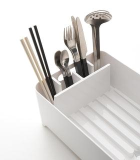 White Dish Rack holding utensil organizer on white background by Yamazaki Home. view 5