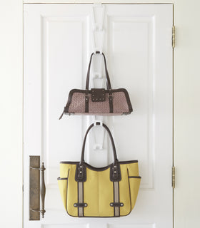 Front view of white Chain Link Bag Hanger holding purses by Yamazaki Home. view 4
