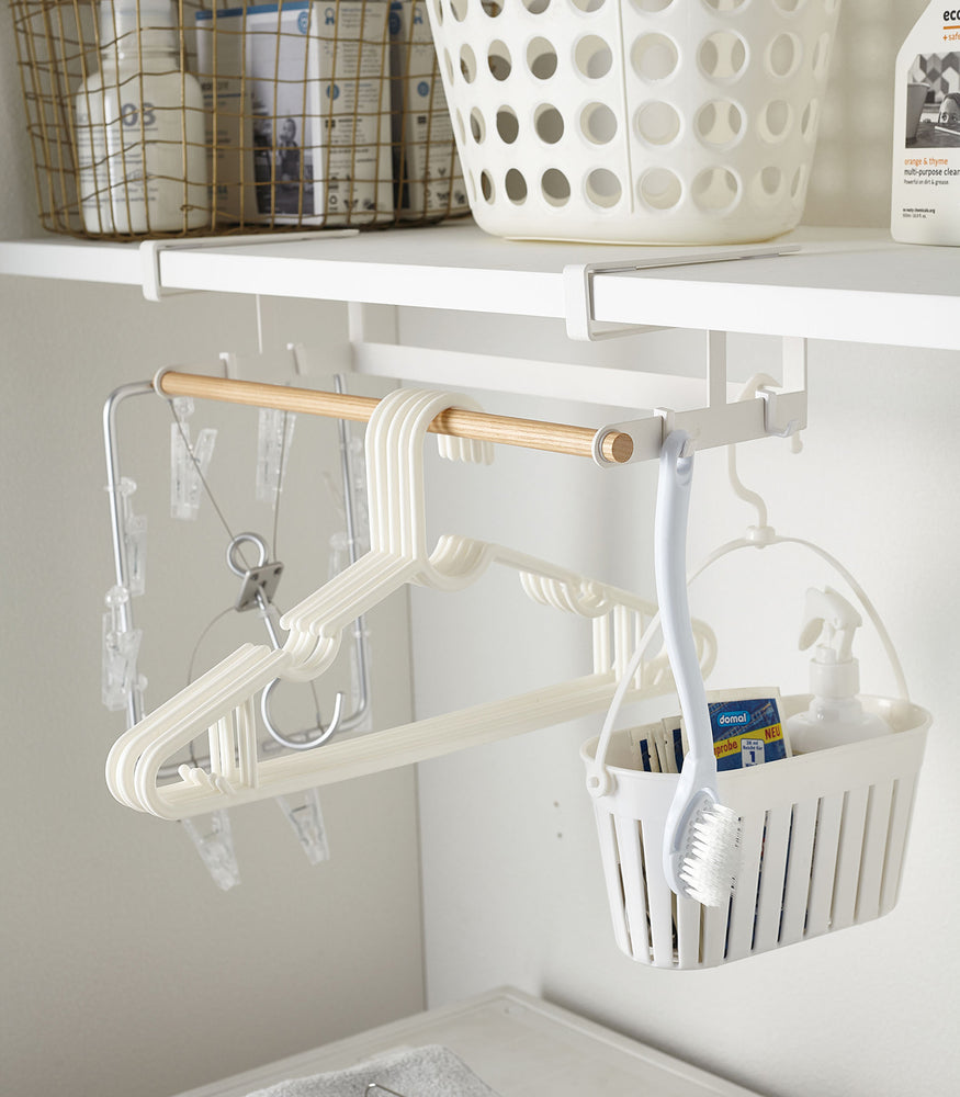 View 7 - White Undershelf Hanger in laundry room holding cleaning supplies by Yamazaki Home.