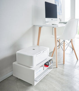 White Rolling Printer Stand holding paper, ink, and computer in office space by Yamazaki Home. view 2