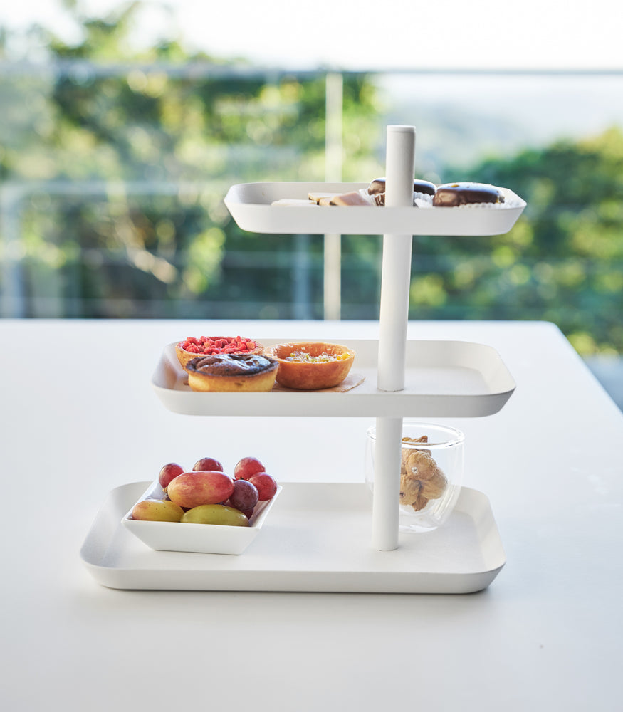 View 5 - Front view of white Serving Stand displaying pastries on white table by Yamazaki Home.