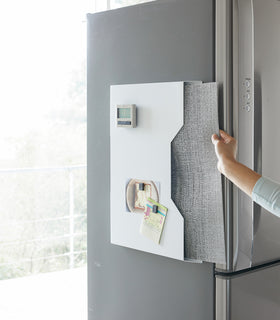 White Magnetic Placemat Organizer holding mats on kitchen fridge by Yamazaki home. view 4