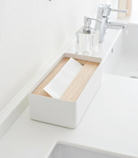 Aerial side view of white Tissue Case on bathroom sink counter by Yamazaki Home. view 3