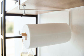 Close-up view of Undershelf Paper Towel Holder holding paper towel roll by Yamazaki Home. view 6
