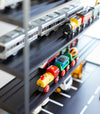 Close up view of black Kid's Parking Garage shelving holding toy trains by Yamazaki Home.