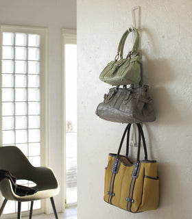 White Chain Link Bag Hanger holding purses on wall by Yamazaki Home. view 5