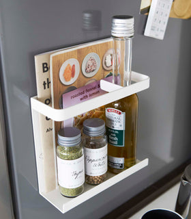White Magnetic Wrap Holder holding books and spices by Yamazaki home. view 6