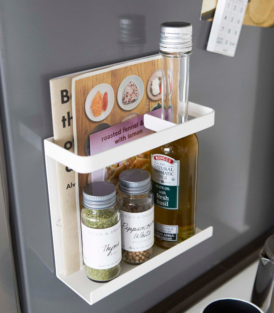 View 6 - White Magnetic Wrap Holder holding books and spices by Yamazaki home.