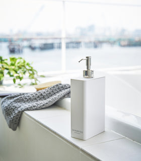 White Shampoo Dispenser in bathroom by Yamazaki Home. view 3