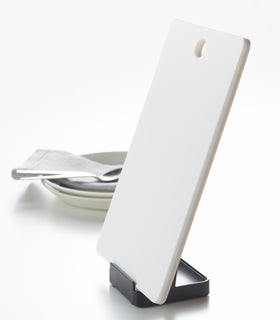 Side view of black Lid & Ladle Stand holding cutting board on white background by Yamazaki Home. view 12