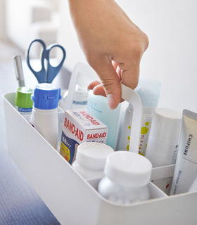Close up view of white Storage Caddy holding first-aid materials by Yamazaki Home. view 5