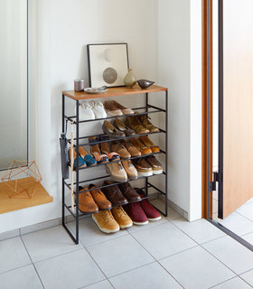 Black entryway Shoe Rack holding shoes by Yamazaki Home. view 10