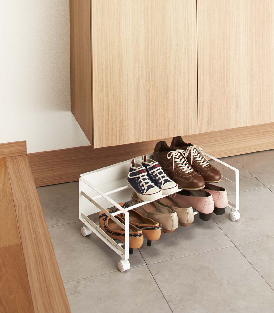 View 2 - White Rolling Shoe Rack holding shoes in bedroom by Yamazaki home.