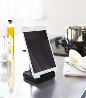 Black Lid & Ladle Stand holding tablet in kitchen by Yamazaki Home. view 10