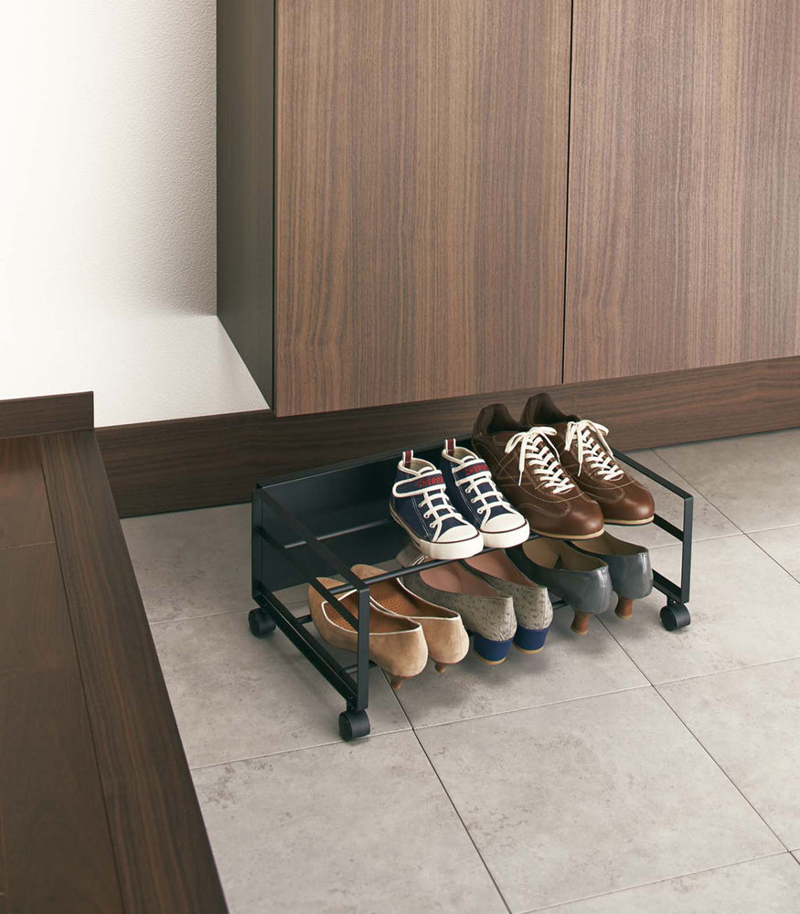 View 6 - Black Rolling Shoe Rack holding shoes by Yamazaki Home.