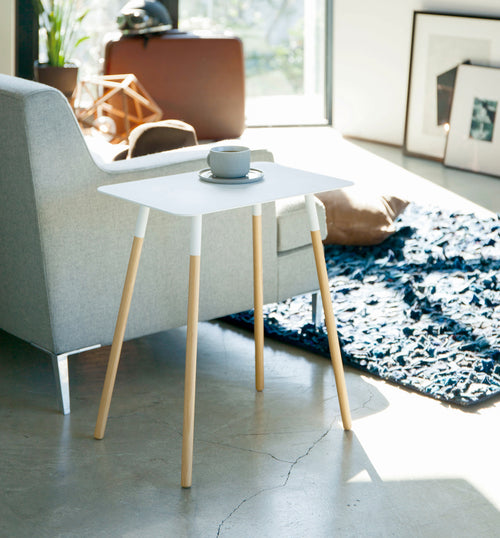 White Side Table holding coffee cup in living room by Yamazaki Home.