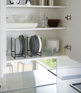 Black Dish Storage Rack displaying plates in kitchen cabinet by Yamazaki Home. view 7