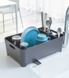 Front view of black Dish Rack containing dinnerware on kitchen counter by Yamazaki Home.