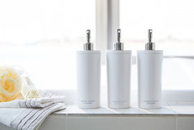 Front view of white Shampoo Dispenser between Body Soap and Conditioner Dispenser in bathroom by Yamazaki Home. view 4