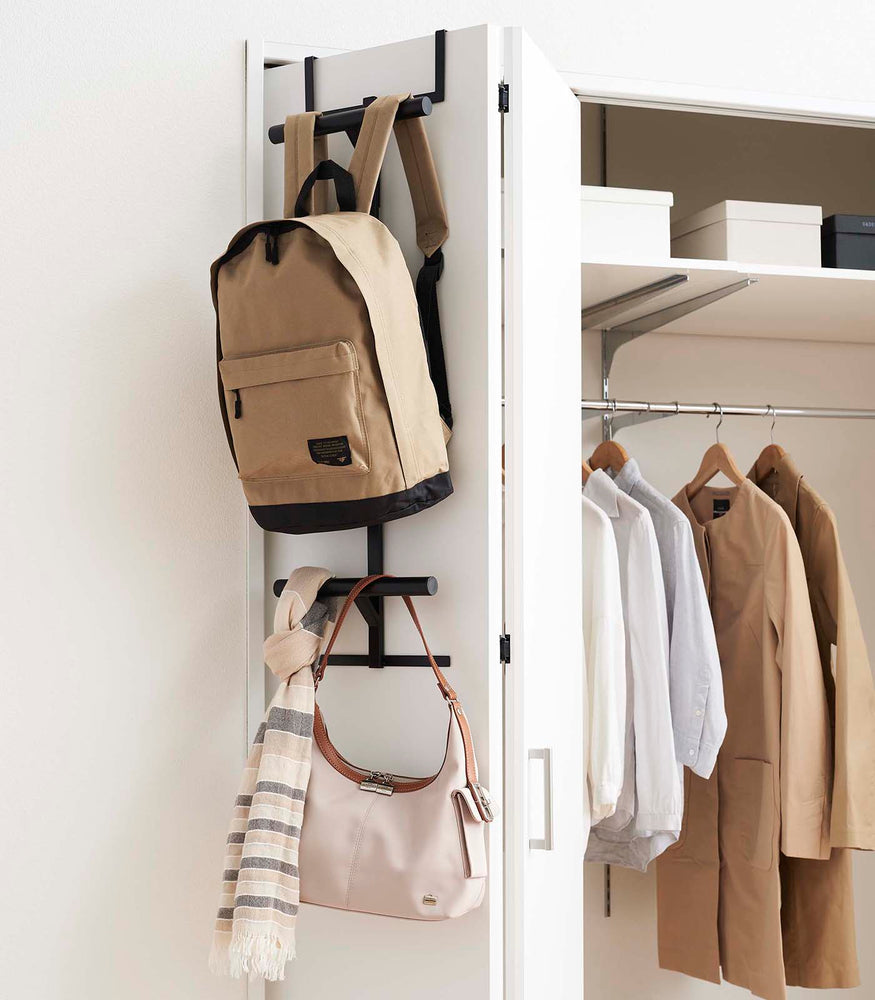 View 8 - Black Kids' Backpack Hanger holding a backpack, purse, and scarf on closet door by Yamazaki Home.