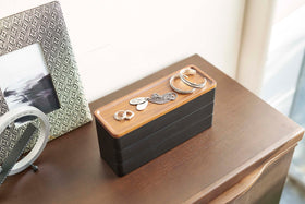 Black Stacking Watch and Accessory Case closed with jewelry on a chest of drawers view 14
