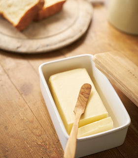 Close up aerial view of ceramic butter dish holding butter on table by Yamazaki Home. view 4