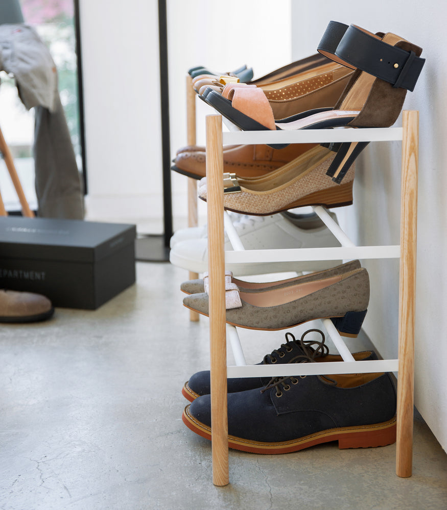 View 6 - Side view of white entryway Expandable Shoe Rack by Yamazaki Home.
