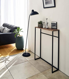 Yamazaki Home Narrow Entryway Console Table with plants next a floor lamp.  view 11