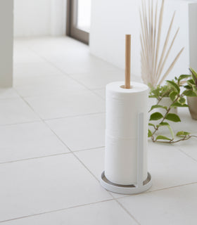 Toilet Paper Stocker holding toilet paper rolls on tile floor by Yamazaki Home. view 5