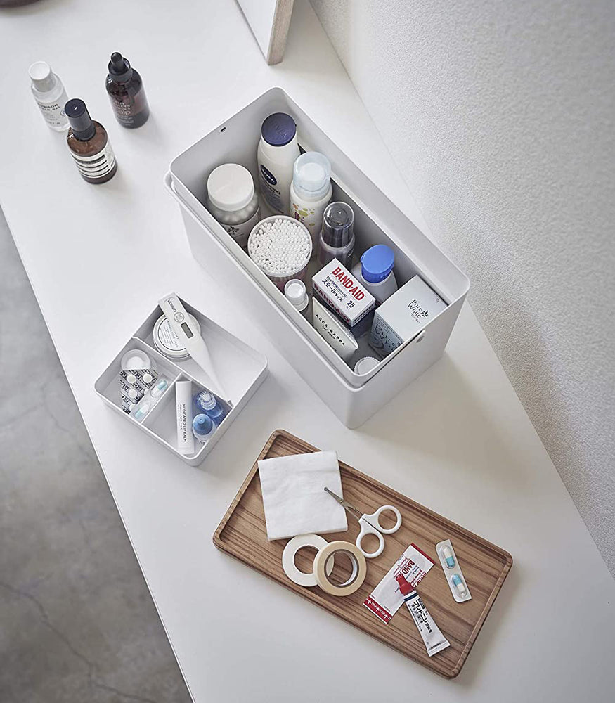 View 2 - Aerial view of white Sewing Kit Organizer holding first-aid items by Yamazaki Home.