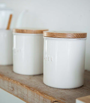Close up side view of Ceramic Coffee Canister on shelf by Yamazaki Home.