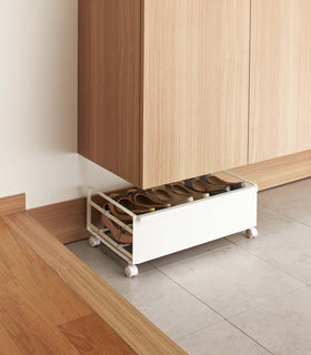 Back profile of white Rolling Shoe Rack holding shoes by Yamazaki home. view 3