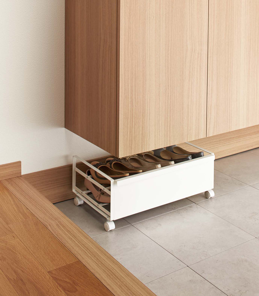 View 3 - Back profile of white Rolling Shoe Rack holding shoes by Yamazaki home.