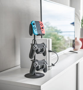 Black Controller Stand holding game controllers on TV stand by Yamazaki Home. view 7